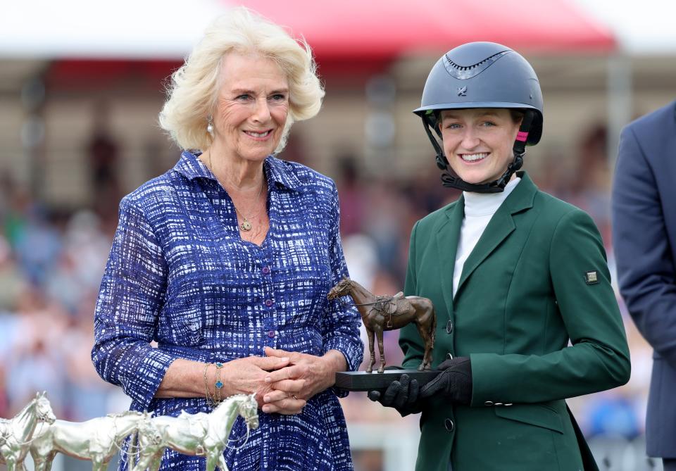 Queen Camilla presents a trophy to second place rider Lucy Latta (Getty Images)