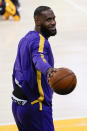 Los Angeles Lakers forward LeBron James points to a person in the stands before the team's NBA basketball game against the New Orleans Pelicans on Friday, Jan. 15, 2021, in Los Angeles. (AP Photo/Ashley Landis)