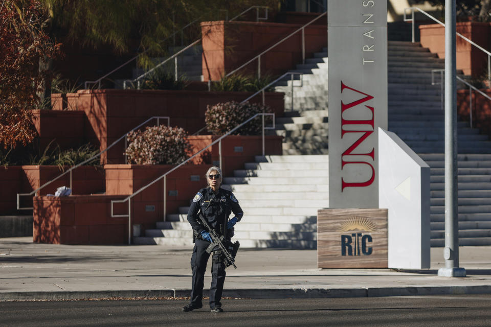 A police officer stands at the scene of a shooting on the University of Nevada, Las Vegas, campus on Wednesday, Dec. 6, 2023, in Las Vegas. (Madeline Carter/Las Vegas Review-Journal via AP)