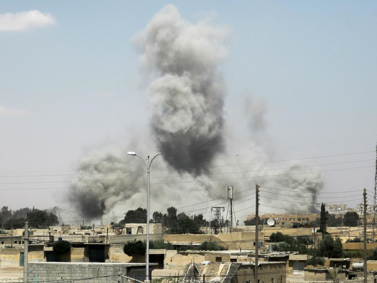 Smoke billows from buildings in the northern Syrian city of Raqqa on 18 June 2017, during an offensive by US-backed fighters to retake the Isis terror group bastion: DELIL SOULEIMAN/AFP/Getty Images