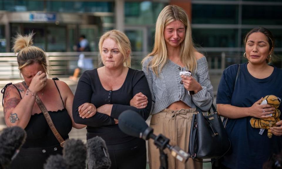 Hollie Dance (second left) surrounded by family and friends, outside the Royal London hospital