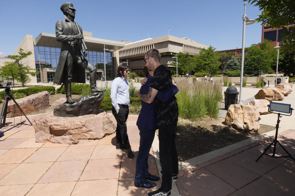 Michael Anderson, center, vice president of operations at Club Q, is hugged by R.J. Lewis, right, as Anderson's brother, Tim, of Tampa, looks on outside the courthouse after a hearing for the suspect in a mass shooting at the gay nightclub Monday, June 26, 2023, in Colorado Springs, Colo. The suspect pleaded guilty in the attack that left five people dead and wounded multiple others just before Thanksgiving Day 2022, at the longtime sanctuary for the LGBTQ+ community in this mostly conservative city. (AP Photo/David Zalubowski)