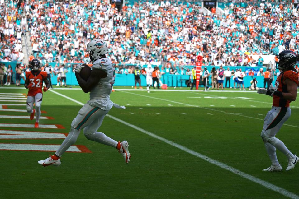 Miami Dolphins running back Raheem Mostert (31) scores a touchdown against the Denver Broncos during the third quarter of an NFL game at Hard Rock Stadium in Miami Gardens, Sept. 24, 2023.