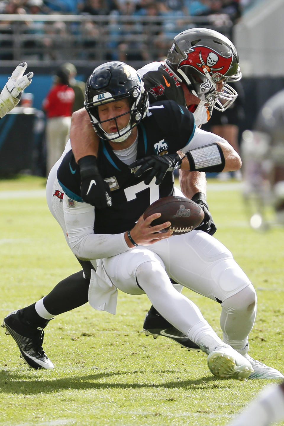 Jacksonville Jaguars quarterback Nick Foles, left, is sacked by Tampa Bay Buccaneers linebacker Carl Nassib during the first half of an NFL football game, Sunday, Dec. 1, 2019, in Jacksonville, Fla. (AP Photo/Stephen B. Morton)