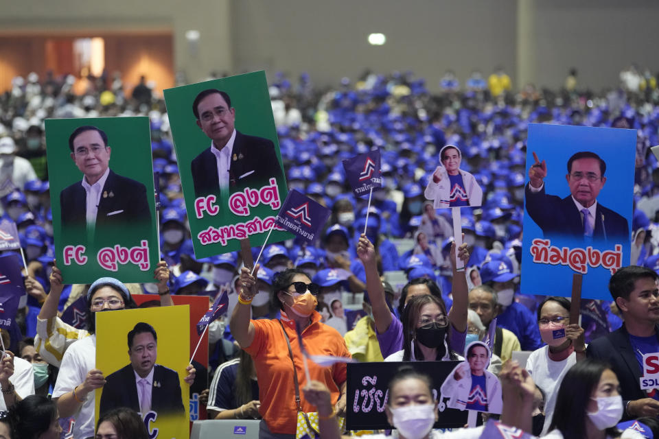 Supporters hold up posters of Thailand's Prime Minister Prayuth Chan-ocha as he officially announces joining the United Thai Nation Party as a newly-established party's candidate in Bangkok, Thailand, Monday, Jan. 9, 2023. Prayuth, who first came to power as army chief leading a coup in 2014, became prime minister in an elected government in 2019 as the candidate of the military-backed Palang Pracharath Party, but has split with his former colleagues to become the candidate for Ruam Thai Sang Chart, or United Thai Nation Party, in this year's not-yet-scheduled general election. (AP Photo/Sakchai Lalit)
