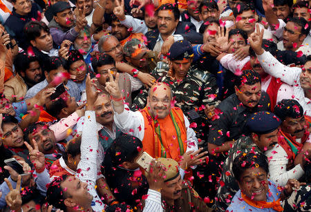 Amit Shah (C), president of India's ruling Bharatiya Janata Party (BJP) gestures as he celebrates with party supporters after learning of the initial poll results inside the party headquarters in New Delhi, India, March 11, 2017. REUTERS/Adnan Abidi