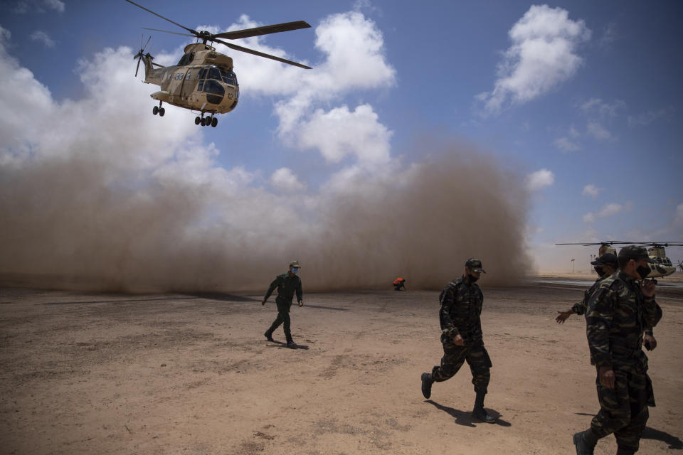 A helicopter flies over at the end of the African Lion military exercise, in Tantan, south of Agadir, Morocco, Friday, June 18, 2021. The U.S.-led African Lion war games, which lasted nearly two weeks, stretched across Morocco, a key U.S, ally, with smaller exercises held in Tunisia and in Senegal, whose troops ultimately moved to Morocco. (AP Photo/Mosa'ab Elshamy)