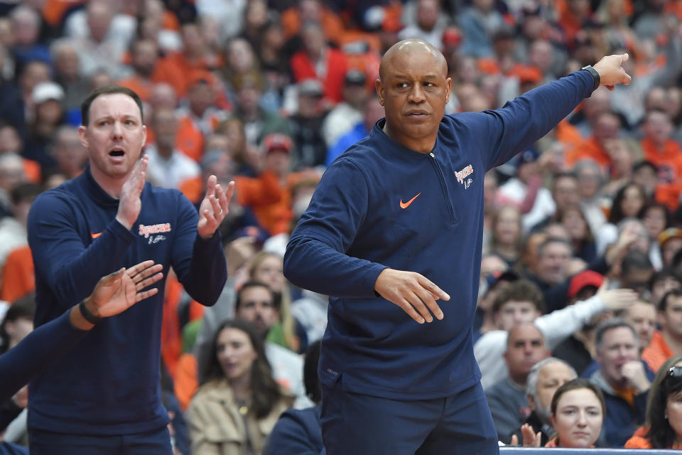 Syracuse head coach Adrian Autry, right, and associate head coach Gerry McNamara gesture during the first half of an NCAA college basketball game against Notre Dame in Syracuse, N.Y., Saturday, Feb. 24, 2024. (AP Photo/Adrian Kraus)