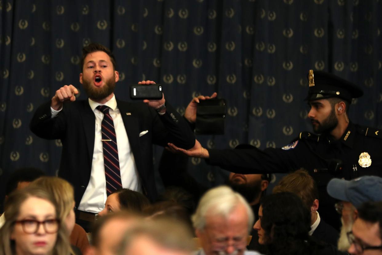 Owen Shroyer, an Infowars host, disrupts the House Judiciary Committee hearing on the impeachment of Donald Trump before being escorted out by police: Getty Images
