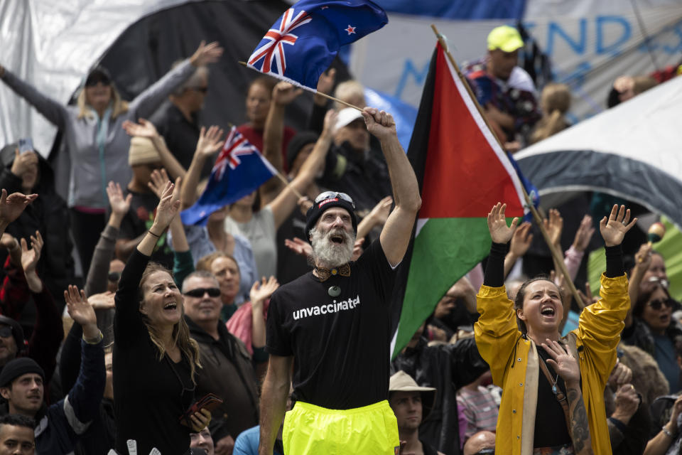 People who oppose vaccine mandates protest near Parliament in Wellington, New Zealand Monday, Feb. 14, 2022. The protesters are not planning to leave any time soon after they drove in convoys from around the country nearly a week ago, setting up tents on Parliament's grounds and blocking surrounding streets with their cars and trucks. (George Heard/New Zealand Herald via AP)