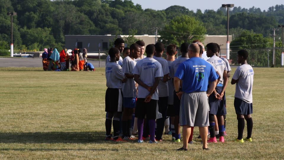 Dan Gish oversees a huddle while players' mothers and sisters huddle in the background in 2016. - Courtesy Amy Bass