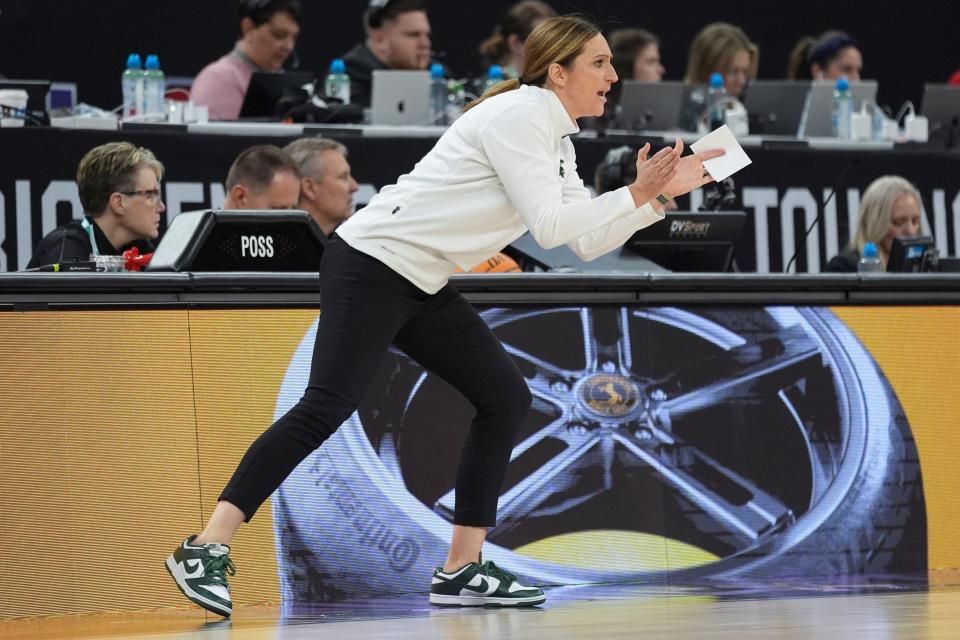 Michigan State head coach Robyn Fralick claps during the first half of an NCAA college basketball quarterfinal game against Nebraska at the Big Ten women's tournament Friday, March 8, 2024, in Minneapolis. (AP Photo/Abbie Parr)