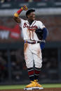 Atlanta Braves' Ronald Acuna Jr. reacts after a video review confirmed he was safe with a steal of second base in the sixth inning of the team's baseball game against the St. Louis Cardinals on Thursday, June 17, 2021, in Atlanta. (AP Photo/John Bazemore)