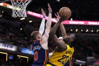 Indiana Pacers forward Aaron Nesmith (23) shoots over New York Knicks guard Donte DiVincenzo (0) during the second half of Game 4 in an NBA basketball second-round playoff series, Sunday, May 12, 2024, in Indianapolis. (AP Photo/Michael Conroy)