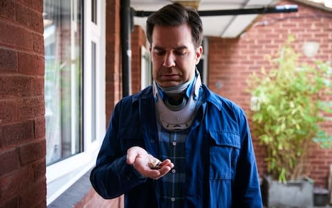 Rob Norris (played by Rob Delaney) is confined to a neck brace following his car crash - Credit: &nbsp;Mark Johnson/Television Stills