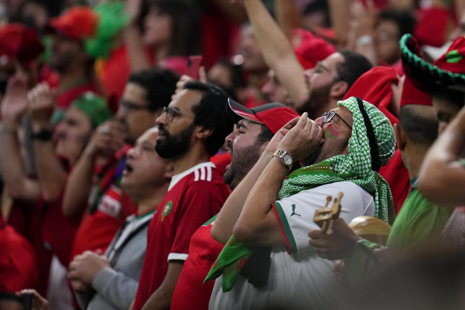 Fans of Morococo sing the national anthem prior to the World Cup semifinal soccer match between France and Morocco at the Al Bayt Stadium in Al Khor, Qatar, Wednesday, Dec. 14, 2022. (AP Photo/Natacha Pisarenko)