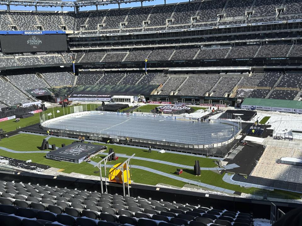 Workers build for the outdoor NHL Stadium Series hockey games at MetLife Stadium in East Rutherford, N.J., Thursday, Feb. 15, 2024. The New Jersey Devils and Philadelphia Flyers play Saturday and the New York Rangers and New York Islanders play Sunday at Metlife Stadium. (AP Photo/Tom Canavan)