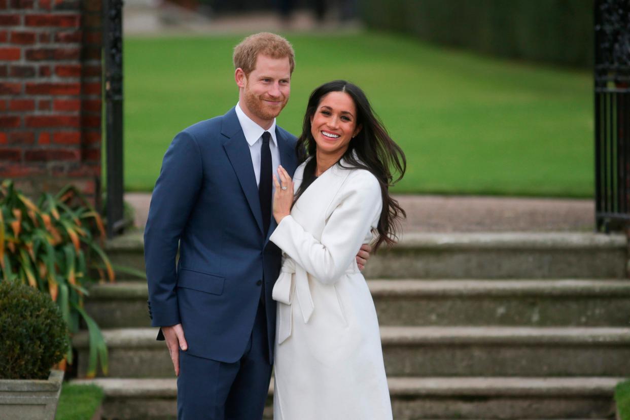 Prince Harry and Duchess Meghan pose for pictures following the announcement of their engagement on Nov. 27, 2017 at Kensington Palace.