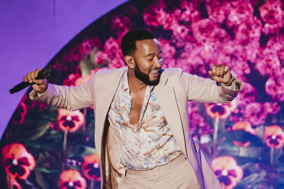 <p>John Legend gets down on Sept. 21 during his show at L.A.'s Greek Theatre. </p>