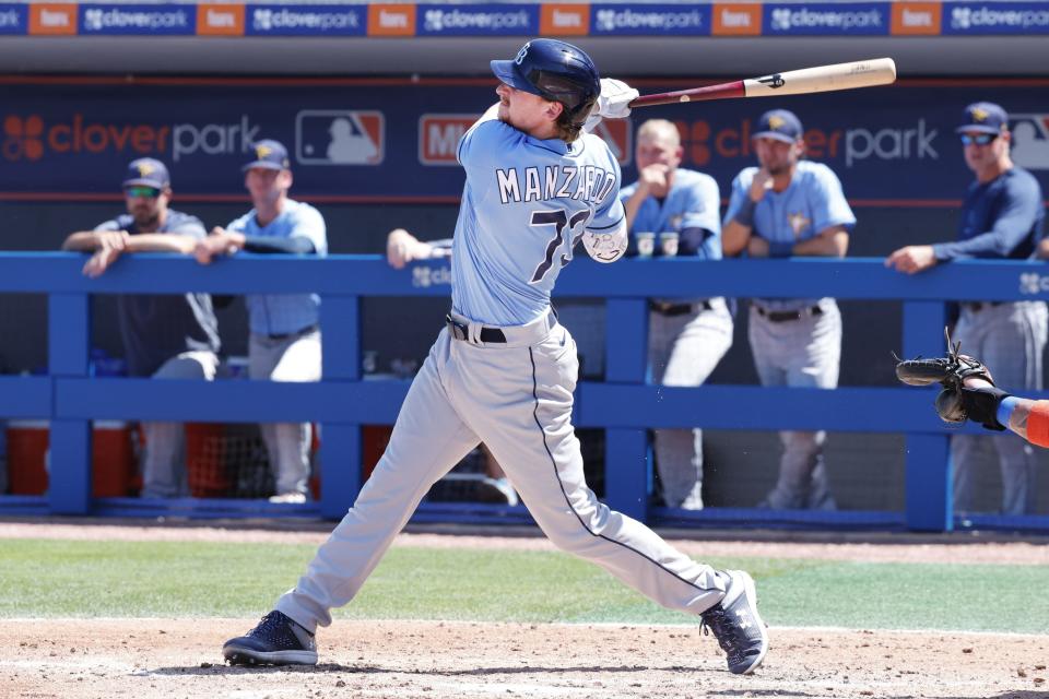 Tampa Bay Rays first baseman Kyle Manzardo hits a home run during spring training against the New York Mets on March 12, 2023, in Port St. Lucie, Fla.