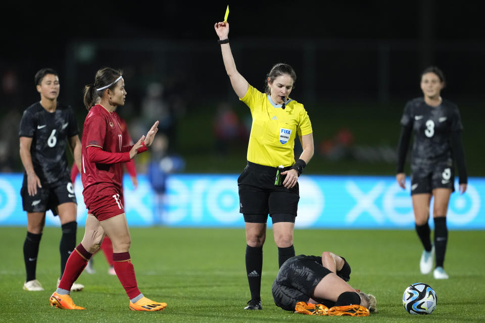 Referee Rebecca Dercau shows a yellow card to Vietnam's Thi Thao Thai, left, following a foul on New Zealand's CJ Bott during the New Zealand and Vietnam warm up match ahead of the women's World Cup in Napier, New Zealand, Monday, July 10, 2023. (AP Photo/John Cowpland)