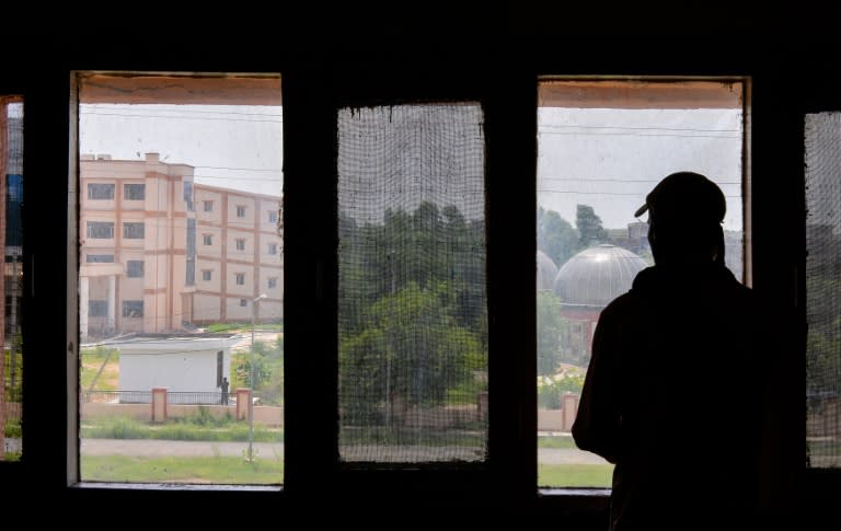 The cousin of a gang rape victim looks out of a window at a government hospital where she is being treated in the city of Rohtak, northern India on July 21, 2016