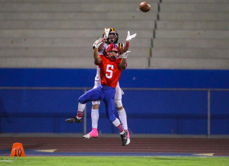 Yucca Valley's Javin Hudson (7) reaches up for a touchdown catch near the 10-yard line while covered b Indio's Esteban Maldonado (5) during the second quarter of their game at Indio High School in Indio, Calif., Friday, Oct. 7, 2022. 