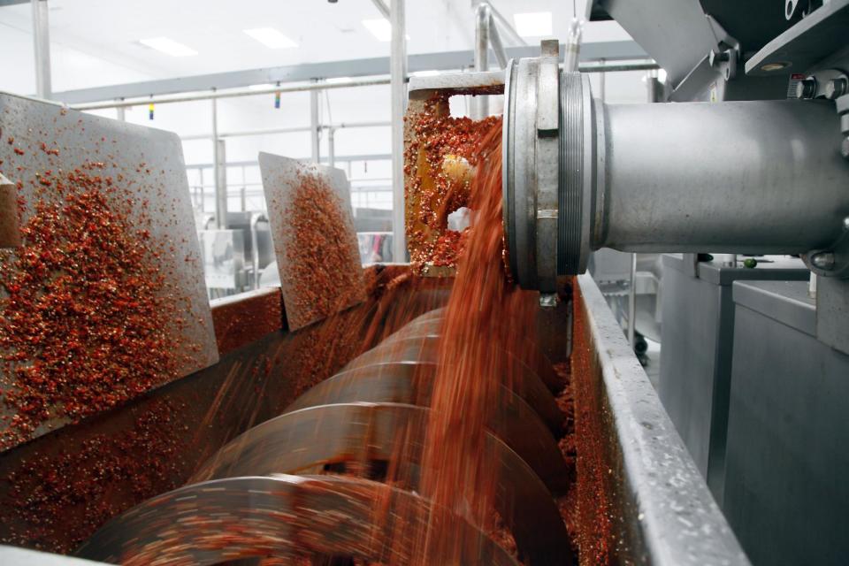 Sriracha chili sauce is produced at the Huy Fong Foods factory in Irwindale, Calif., on Tuesday, Oct 29, 2013. The maker of Sriracha hot sauce is under fire for allegedly fouling the air around its Southern California production site. The city of Irwindale filed a lawsuit in Los Angeles Superior Court Monday asking a judge to stop production at the Huy Fong Foods factory, claiming the chili odor emanating from the facility is a public nuisance. (AP Photo/Nick Ut)