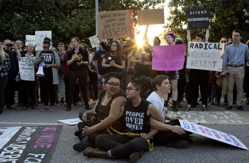 Anti-HB2 protesters sit chained together