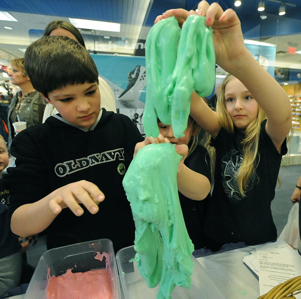 From left, Jeff Cromer, then 10, Gary Whitehouse, then 6, and Ava Whitehouse, then 7, play with slime at the Salvation Army's exhibit at a previous Celebrate Children festival. Celebration of Children, which is similar to Celebrate Children, will be held Saturday this year.