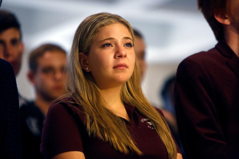 Stoneman Douglas High School Junior Class President Jaclyn Corin's, 17, eyes well with tears as she listens to a fellow student tell his story during a press conference at the Capitol in Tallahassee.