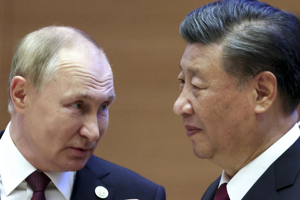 Russian President Vladimir Putin, left, speaks to Chinese President Xi Jinping during the Shanghai Cooperation Organization (SCO) summit in Samarkand, Uzbekistan, Friday, Sept. 16, 2022. (Sergei Bobylev, Sputnik, Kremlin Pool Photo via AP)