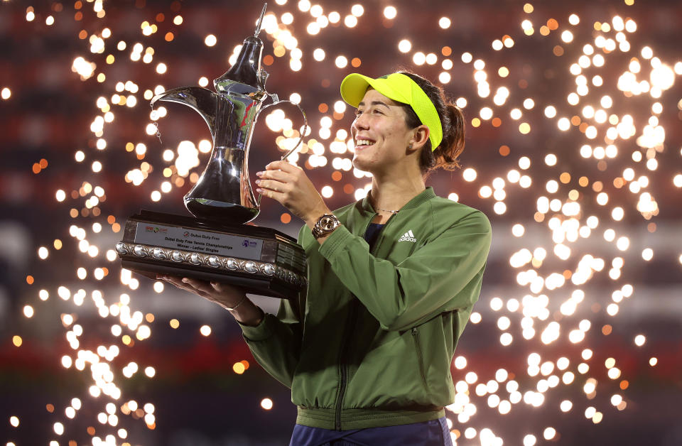 DUBAI, UNITED ARAB EMIRATES - MARCH 13: Garbine Muguruza of Spain celebrates with the trophy following victory during the Dubai Duty Free Tennis Women's Final match between Barbora Krejcikova and Garbine Muguruza on Day Seven of the Dubai Duty Free Tennis at Dubai Duty Free Tennis Stadium on March 13, 2021 in Dubai, United Arab Emirates. (Photo by Francois Nel/Getty Images)