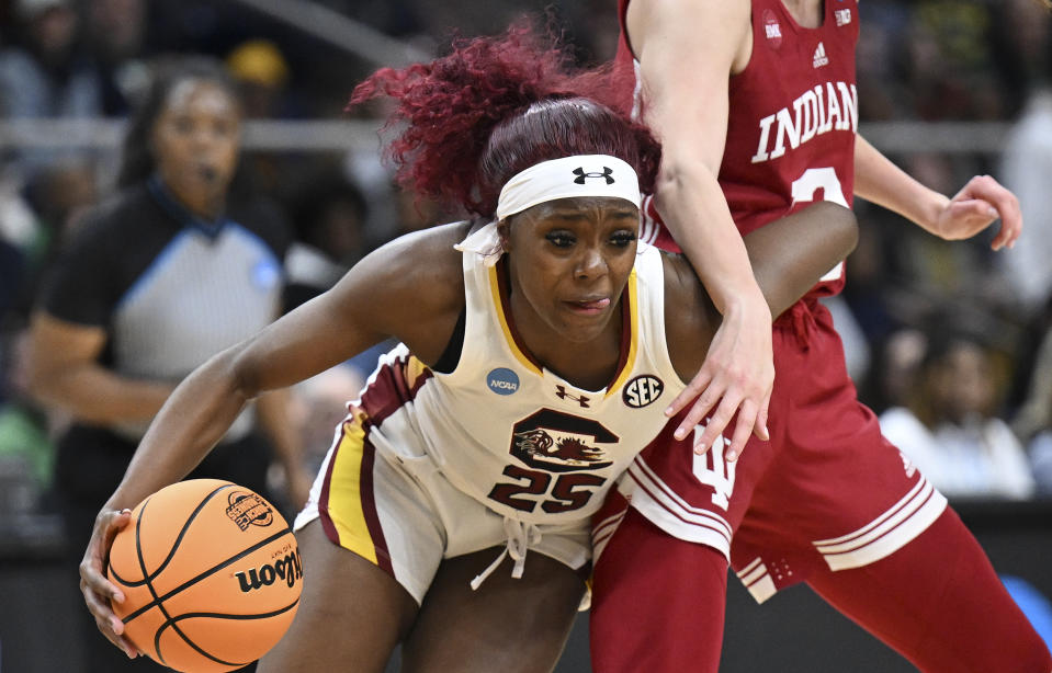 South Carolina guard Raven Johnson (25) drives around Indiana guard Yarden Garzon (12) during the first half of a Sweet Sixteen round college basketball game during the NCAA Tournament, Friday, March 29, 2024, in Albany, N.Y. (AP Photo/Hans Pennink)