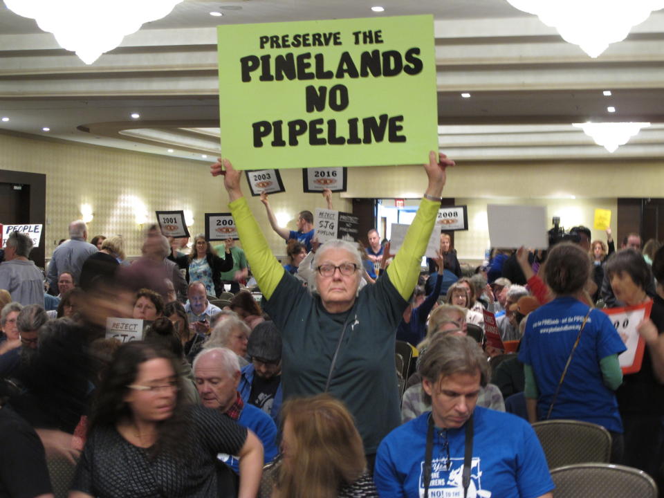 Opponents of a proposed natural gas line that would run through New Jersey's federally protected Pinelands reserve gather inside a hotel in Cherry Hill N.J. Friday Feb. 24, 2017 before a Pinelands Commission meeting at which the proposal was to be voted on. The pipeline has become one of the most hotly contested jobs vs. environment clashes in recent New Jersey history. (AP Photo/Wayne Parry)