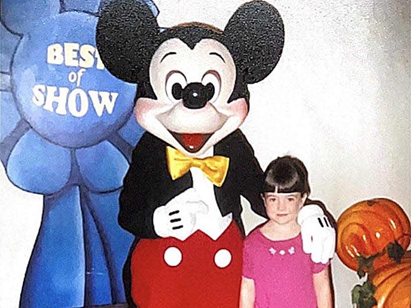 megan posing for a photo with mickey at disney world 30 years ago