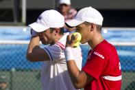 Canadian tennis player Daniel Nestor (L) and Vasek Pospisil (R) prepar a strategy against Israeli tennis team players Jonathan Erlich and Andy Ram of Israel tennis team during their Davis Cup world group doubles playoff tennis match in Ramat Hasharon near Tel Aviv on September 17, 2011. AFP PHOTO/JACK GUEZ (Photo credit should read JACK GUEZ/AFP/Getty Images)