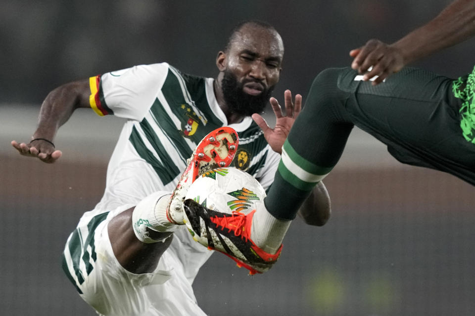 Nigeria's Calvin Bassey, right, challenges Cameroon's Moumi Ngamaleu during the African Cup of Nations Round of 16 soccer match between Nigeria and Cameroon, at the Felix Houphouet Boigny stadium in Abidjan, Ivory Coast, Saturday, Jan. 27, 2024. 2024. (AP Photo/Sunday Alamba)