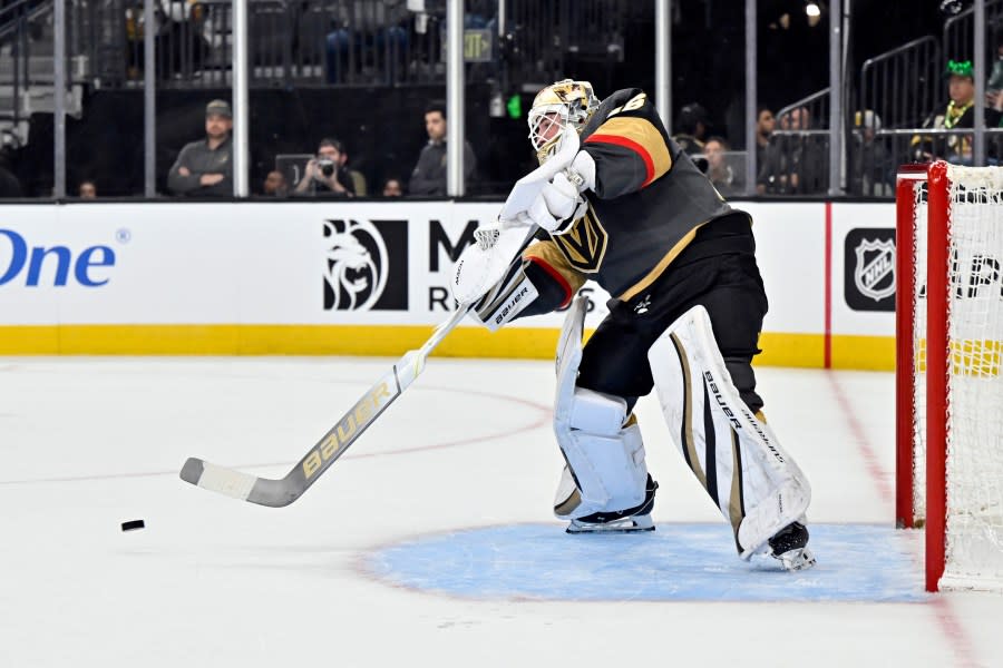 Vegas Golden Knights goaltender Logan Thompson bats the puck away during the first period of an NHL hockey game against the New Jersey Devils Sunday, March 17, 2024, in Las Vegas. (AP Photo/David Becker)