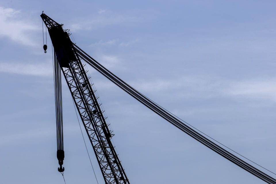 A crane stands by at Tradepoint Atlantic terminal near the wreckage of the Francis Scott Key Bridge, Saturday, March 30, 2024, in Baltimore. (AP Photo/Julia Nikhinson)