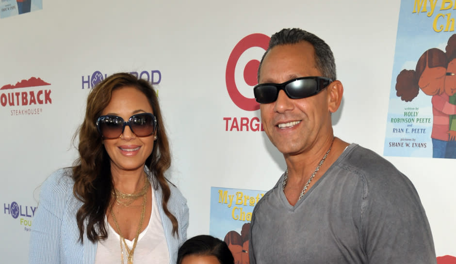 Leah Remini with Angelo Pagan and daughter at red carpet event.