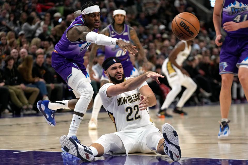 New Orleans Pelicans forward Larry Nance Jr. (22) passes the ball as Utah Jazz forward Jarred Vanderbilt, left, defends during the first half of an NBA basketball game Thursday, Dec. 15, 2022, in Salt Lake City. (AP Photo/Rick Bowmer)