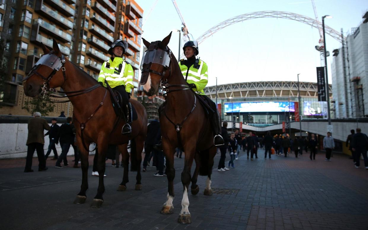 Police horses are routinely used for crowd control at football matches, such as this Spurs game at Wembley - Action Plus