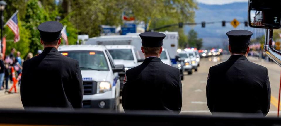 Star Fire Department personnel stand dressed in honor uniforms at the corner of Highway 44 and Star Road. A procession of law enforcement vehicles escorting the body of Ada County Sheriff's Deputy Tobin Bolter, who was killed in the line of duty, passed through Star on its way to Bolter’s funeral at the Ford Idaho Center in Nampa. Darin Oswald/doswald@idahostatesman.com