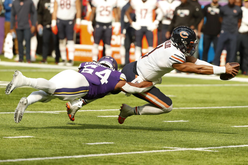 Chicago Bears quarterback Justin Fields (1) is tackled by Minnesota Vikings linebacker Eric Kendricks (54) during the second half of an NFL football game, Sunday, Oct. 9, 2022, in Minneapolis. (AP Photo/Bruce Kluckhohn)