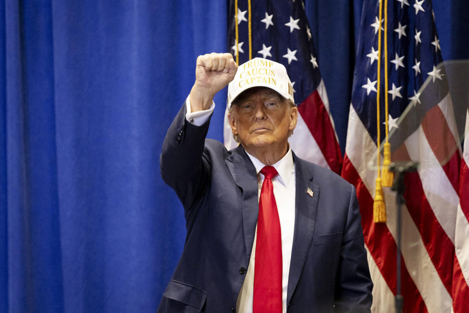 Former President Donald Trump raises his fist at a 