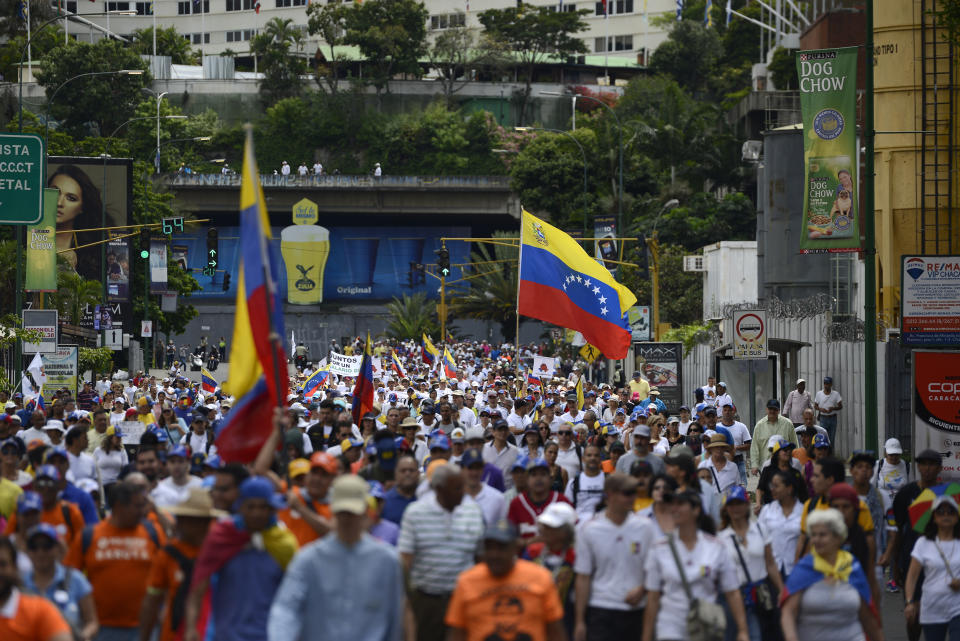 A crowd carrying flags and blowing whistles gather in a demonstration led by opposition politician Juan Guaido, who’s urging masses into the streets to force President Nicolás Maduro from power, in Caracas, Venezuela, Saturday, Nov. 16, 2019. Guaido called nationwide demonstrations to re-ignite a campaign against Maduro launched in January that has lost steam in recent months. (AP Photo/Matias Delacroix)