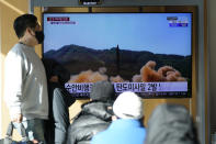 People watch a TV screen showing a news program reporting about North Korea's missile launch with a file footage at a train station in Seoul, South Korea, Monday, Jan. 17, 2022. North Korea on Monday fired two suspected ballistic missiles into the sea in its fourth weapons launch this month, South Korea's military said, with the apparent goal of demonstrating its military might amid paused diplomacy with the United States and pandemic border closures. (AP Photo/Lee Jin-man)