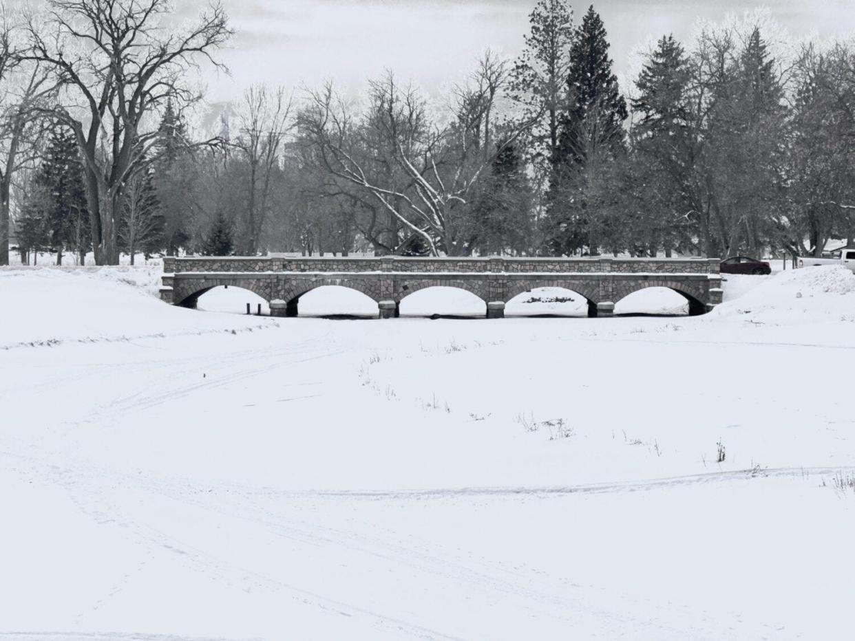 The Big Sioux River under Watertown's stone bridge on Kemp Avenue in winter.