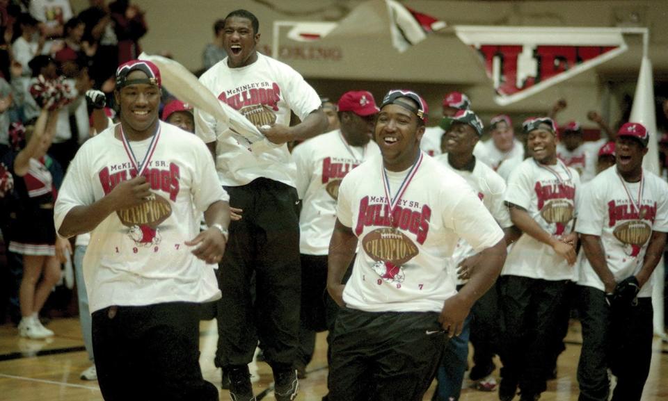 Players on the McKinley High School 1997 state championship football team celebrate their title inside Memorial Field House after the season.